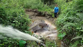 The girl caught a lot of fish in the lake by using a pump to suck all the water in the lake