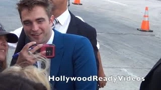 Rob Pattinson shows love to fans at The Rover premiere in Westwood