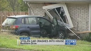 Stolen car crashes into house