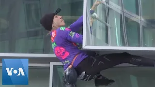 Climber Scales Paris Building in Climate Protest