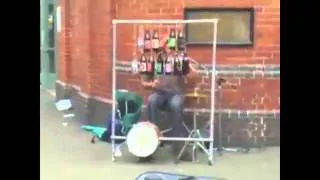 AMAZING! Street artist plays Inspector Gadget song with beer bottles!