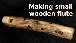 Making small wooden flute from branch