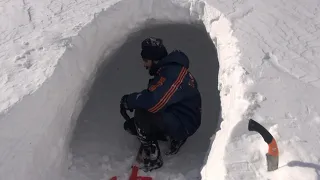 Building a shelter under the snow in harsh conditions and stormy weather