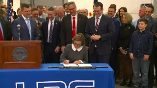 Reynolds signs historic Iowa tax reform into law