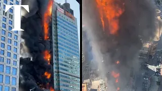 Massive fire tears through high-rise building in China