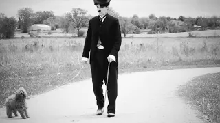 Charlie Chaplin walking his dog.