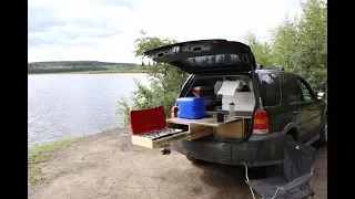 "How to convert an SUV into a camper with a kitchen and sleeping platform."