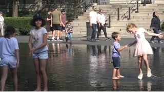 CHICAGO - Children having a blast playing in the Crown Fountain. [4K]