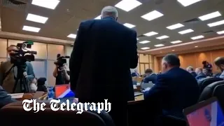 Russian politician demands an end to Putin's war in a rare protest at a local parliament meeting