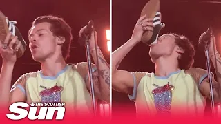 Harry Styles downs drink from his shoe live on stage