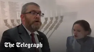 Polish MP uses fire extinguisher to snuff out Jewish menora in parliament
