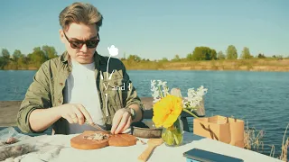 relaxing outdoor cooking galician-style octopus with potatoes on a campfire by a lake with seagulls