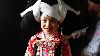Miao girls wear their ancestors' hair for New Year festival