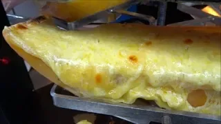 STREET FOOD AT BOROUGH MARKET LONDON, RACLETTE - MELTED CHEESE POURED OVER POTATOES