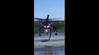 Type 1 heli-tanker helicopter filling water tank to fight wildfire