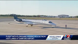 Families reunite after plane bringing Floridians from Haiti lands in Sanford