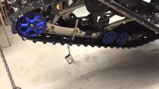 How to adjust track tension on a snowmobile