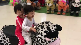 Twin Babies are riding horse toy at indoor playground - Twin Babies!!