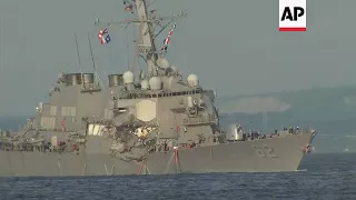 Japan - Damaged US warship towed to port after collision / Collision damage clearly visible on US sh