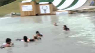 Girl does a backflop from waterslide