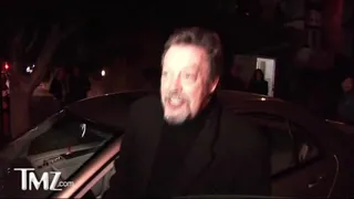 Tim Curry getting into his car.