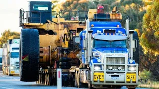 Australian Mack Titans trucks hauling oversize load Cat 793C mining dump trucks, Western Australia 2