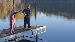 Little Girl Catches Fish While Fishing With Dad and Brother - 1262842