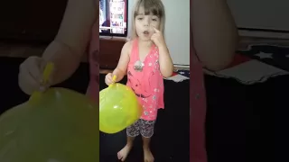 Trinity blowing up magic plastic balloon