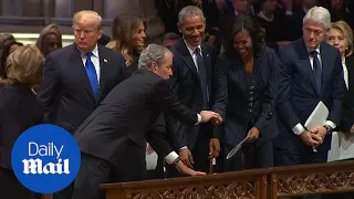 George W. Bush gives Michelle Obama candy at father's funeral