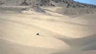 guy jumps huge step up on atv at little sahara sand dunes utah