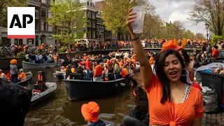 Dutch capital turns orange as revelers celebrate King's Day with colorful canal parade