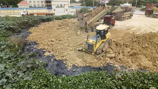 Excellent SHANTUI Dozer DH7C2 Push Rock To Clear the Lake Process With SHAMAN Dump Truck And Trago