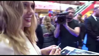 Elizabeth Olsen hugging a fan