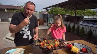 GRILLED MEAT with VEGGIES on a FRYING PAN.