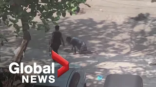 Video shows Myanmar police officer forcing protester to crawl in street