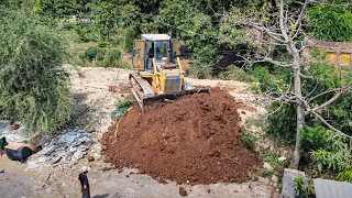 First open project huge equipment working in small place,bulldozer push soil dump truck loading soil