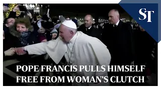 Pope Francis pulls himself free from woman's clutch