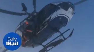 Dramatic moment helicopter rescues injured skier in Alps