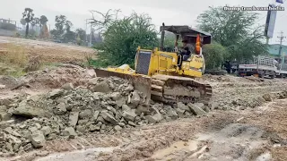 New project!! Dump truck and bulldozer kumatsu push paving stones on the road.