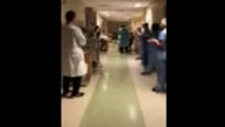 David HoSang receives a "clap out" after recovering from COVID-19.