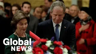 George W. Bush revisits his father, George H. W. Bush's casket, at the Capitol building