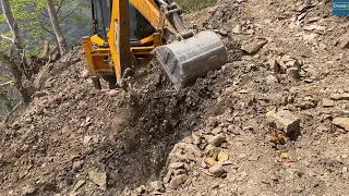 Cutting Rocky Mountainside to Build Hill Top Road on Windy Day