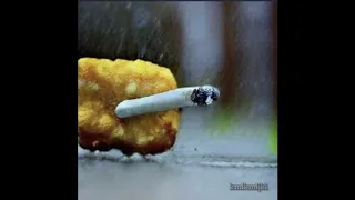 a chicken nugget smoking a cigarette in the rain