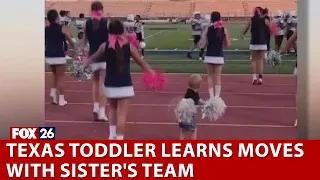 Texas toddler learns new cheerleading moves with sister's team