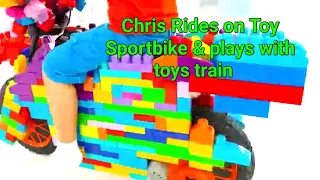 Chris Rides on Toy Sportbike & plays with toys train