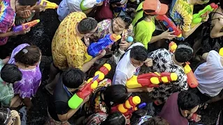 Songkran water festival in Silom, Bangkok. Huge street water fight. Thailand New Year celebration.