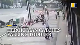 Heroic man catches falling toddler in China