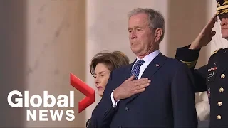 Emotional George W. Bush watches as his father's casket arrives at U.S. Capitol