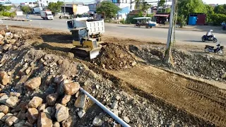 perfectly Action! Installing first foundation road by cat bulldozer d4c & tipper trucks unloading