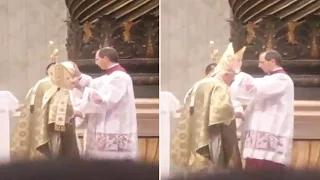 Mons. Marini tidying up Pope's hair at the end of Holy Mass